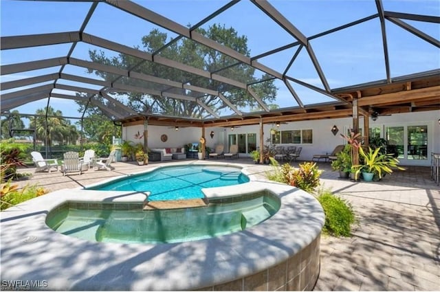 view of swimming pool with a patio area, ceiling fan, and glass enclosure