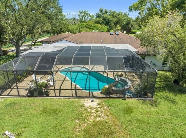 view of swimming pool featuring a lawn, glass enclosure, and a patio area