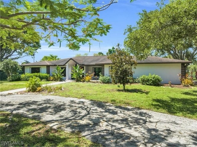 ranch-style home with a front yard