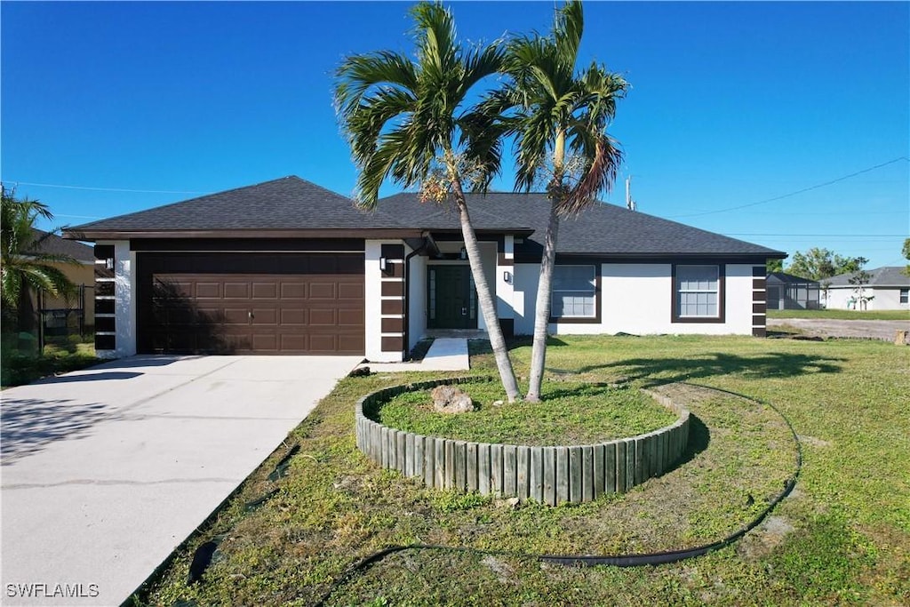 view of front facade featuring a garage and a front lawn