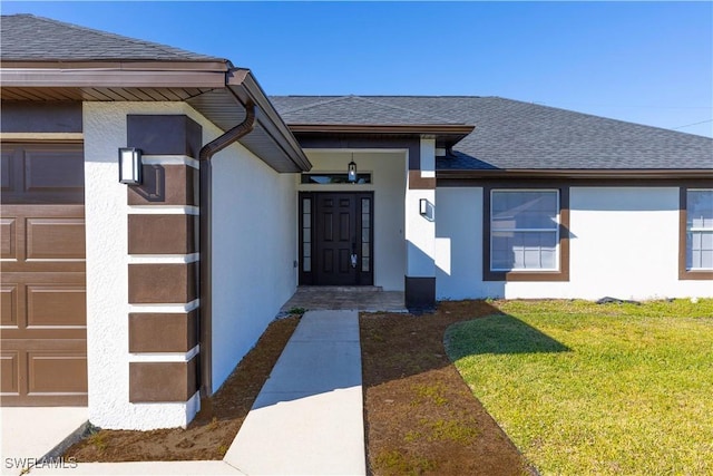 property entrance with a garage and a yard