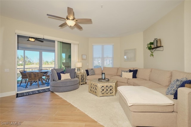 living room with hardwood / wood-style floors, ceiling fan, and a healthy amount of sunlight