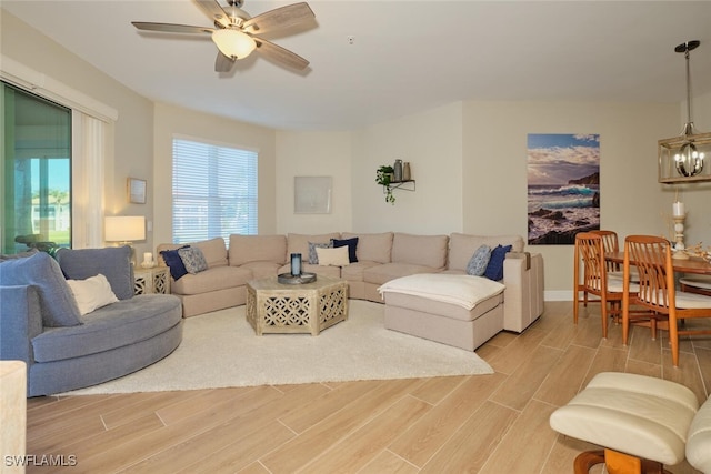 living room with light hardwood / wood-style floors and ceiling fan