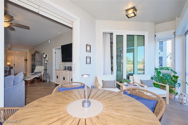 dining area featuring ceiling fan and dark wood-type flooring