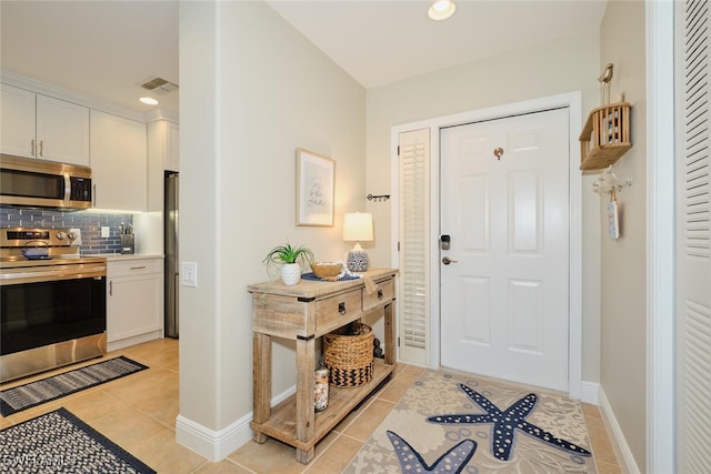 entryway with light tile patterned floors