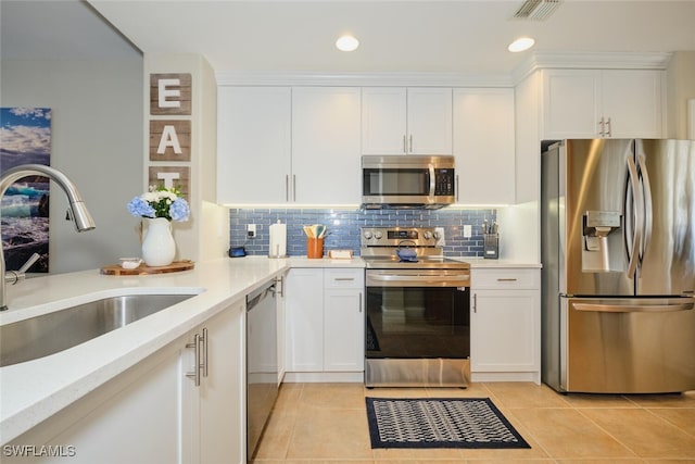 kitchen with appliances with stainless steel finishes, white cabinetry, and sink