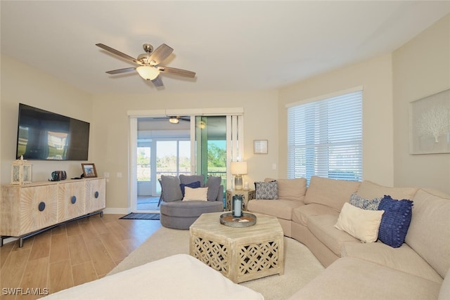 living room with wood-type flooring and ceiling fan