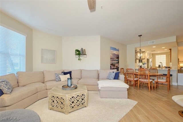 living room featuring a chandelier and hardwood / wood-style floors