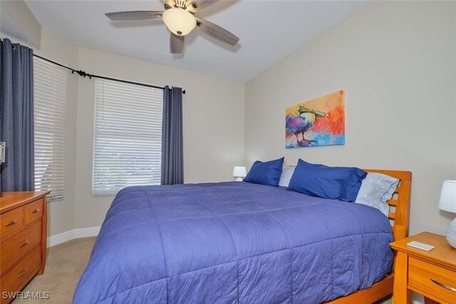 bedroom with light colored carpet and ceiling fan