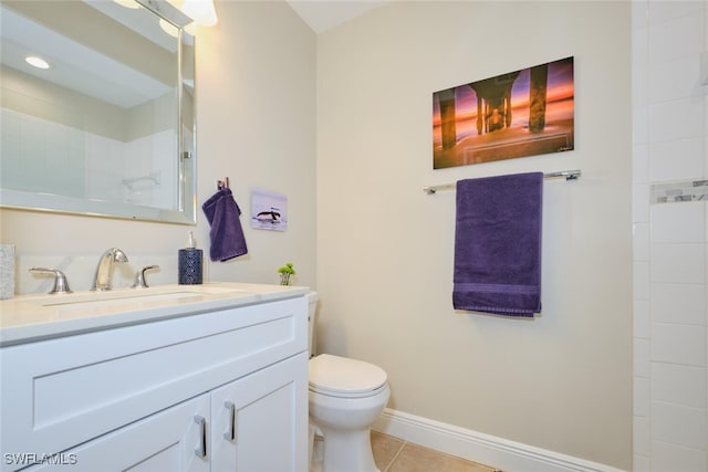 bathroom with tile patterned flooring, vanity, toilet, and tiled shower