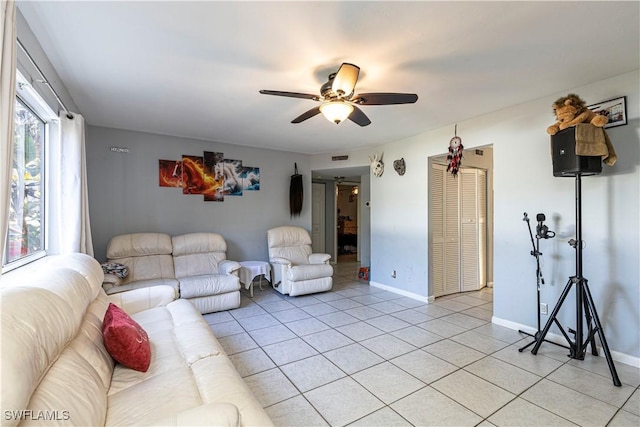 living room with ceiling fan and light tile patterned floors