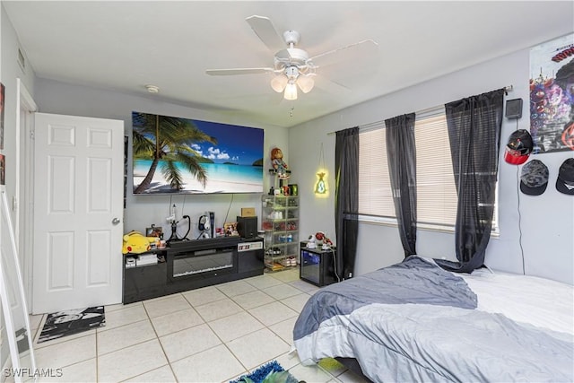 bedroom with ceiling fan and light tile patterned floors