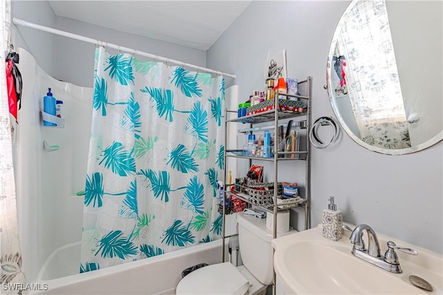 full bathroom featuring toilet, sink, and shower / tub combo with curtain