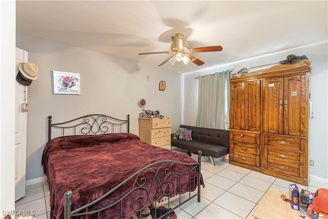 tiled bedroom featuring ceiling fan