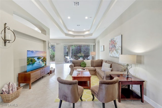 tiled living room with a raised ceiling