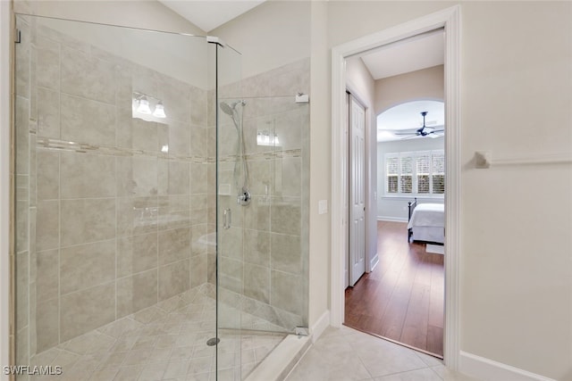 bathroom with tile patterned floors, ceiling fan, and an enclosed shower