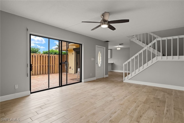 unfurnished living room featuring ceiling fan and light hardwood / wood-style flooring