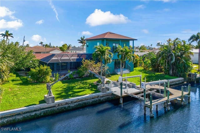 dock area featuring a lanai, a lawn, and a water view