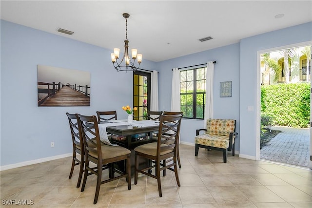 dining space featuring light tile patterned floors and a chandelier