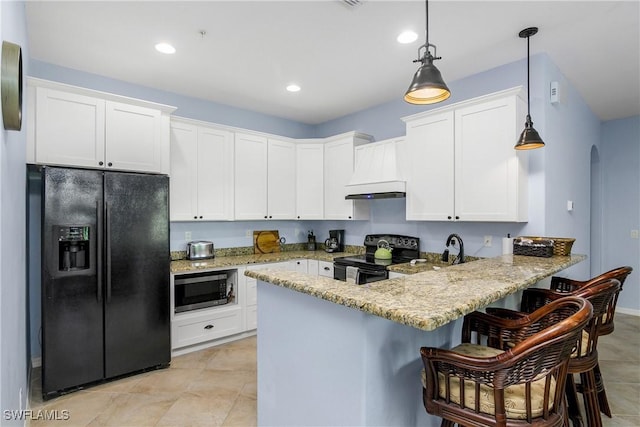 kitchen with black appliances, kitchen peninsula, custom range hood, decorative light fixtures, and white cabinetry