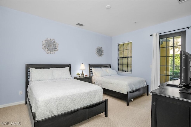 bedroom featuring light carpet