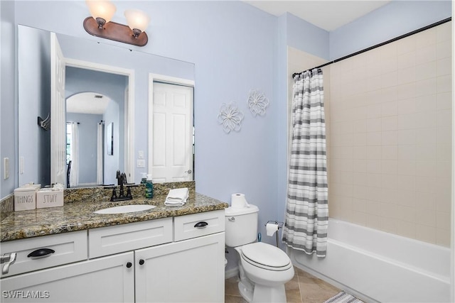 full bathroom with tile patterned flooring, shower / bath combo, toilet, and vanity