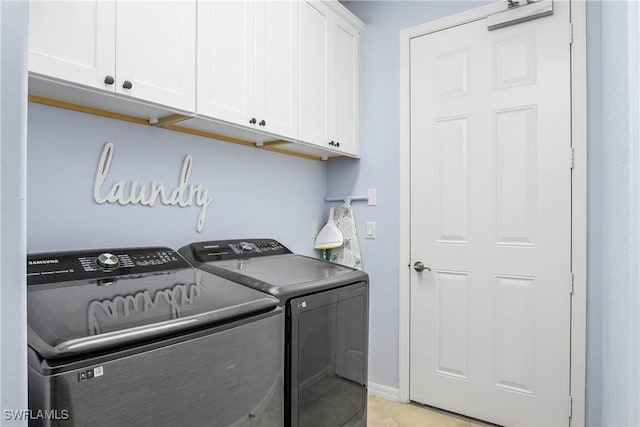 washroom featuring light tile patterned floors, cabinets, and independent washer and dryer