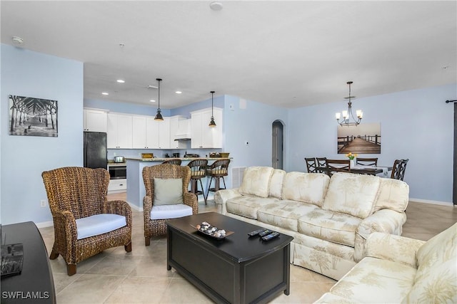 living room featuring an inviting chandelier and light tile patterned flooring