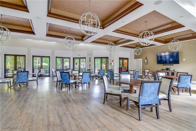 dining space featuring coffered ceiling, an inviting chandelier, beamed ceiling, and light hardwood / wood-style flooring