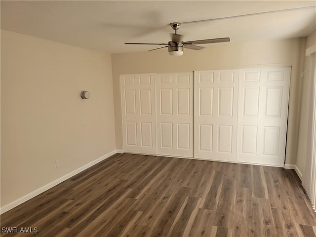 unfurnished bedroom featuring a closet, ceiling fan, and dark wood-type flooring