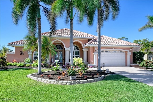 mediterranean / spanish-style house featuring a garage and a front yard