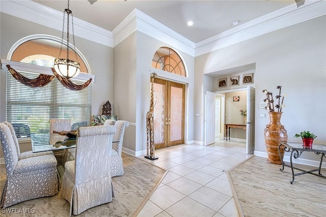 dining space featuring french doors, light tile patterned floors, an inviting chandelier, and ornamental molding