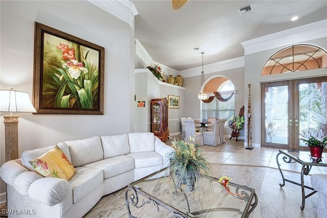 tiled living room featuring crown molding and french doors