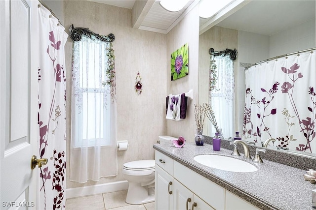 bathroom featuring toilet, vanity, tile patterned floors, and a wealth of natural light