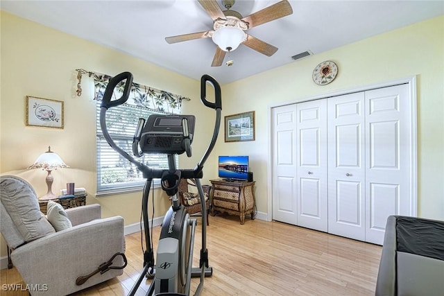 exercise area with ceiling fan and light hardwood / wood-style floors