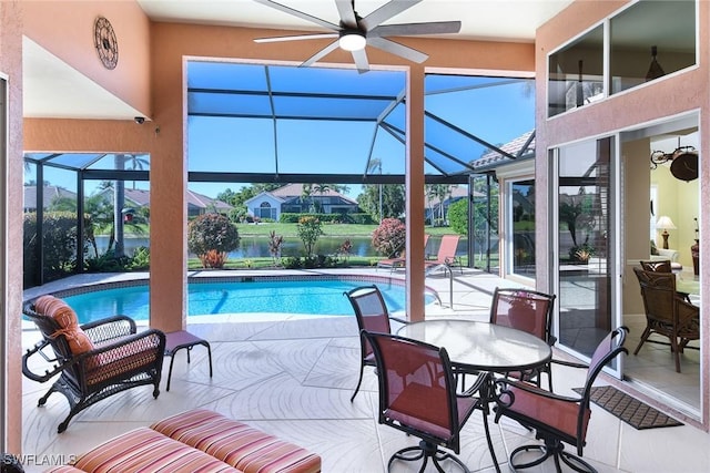 view of swimming pool with ceiling fan, a patio area, and a lanai