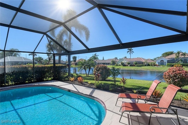 view of swimming pool with a lanai, a patio area, and a water view