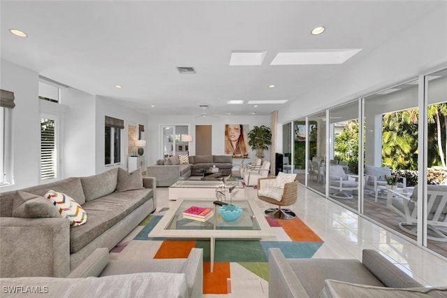 tiled living room featuring ceiling fan