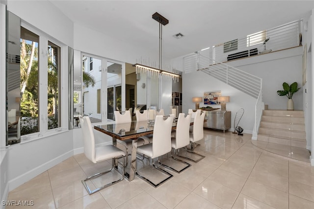 dining room with light tile patterned flooring and an inviting chandelier