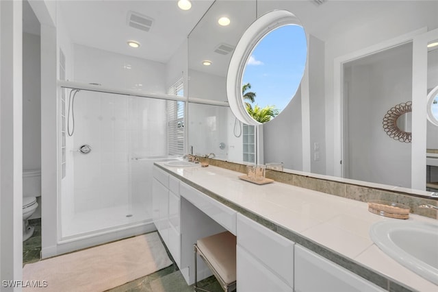 bathroom featuring vanity, an enclosed shower, and toilet