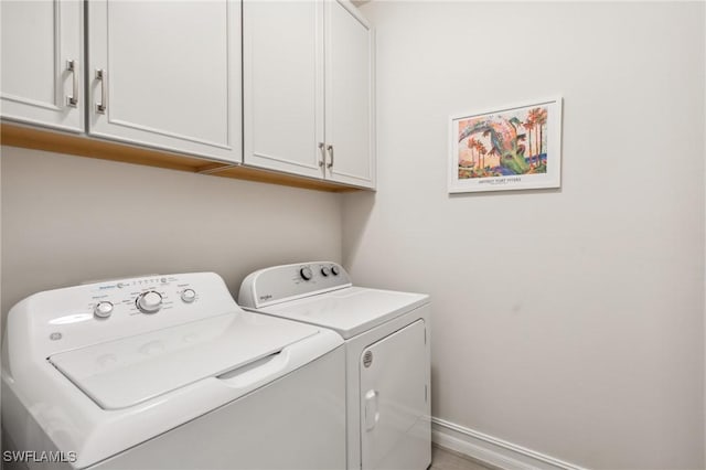 laundry area featuring cabinets and separate washer and dryer