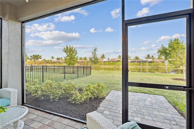 sunroom / solarium with a water view