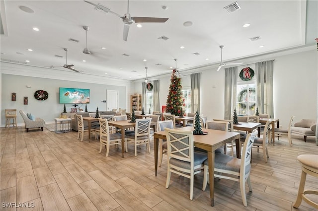 dining room with ceiling fan, light hardwood / wood-style flooring, and crown molding