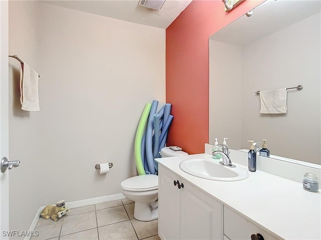 bathroom with tile patterned flooring, vanity, and toilet