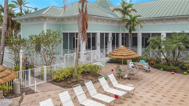 view of patio / terrace featuring a sunroom