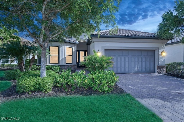 mediterranean / spanish-style house with a garage