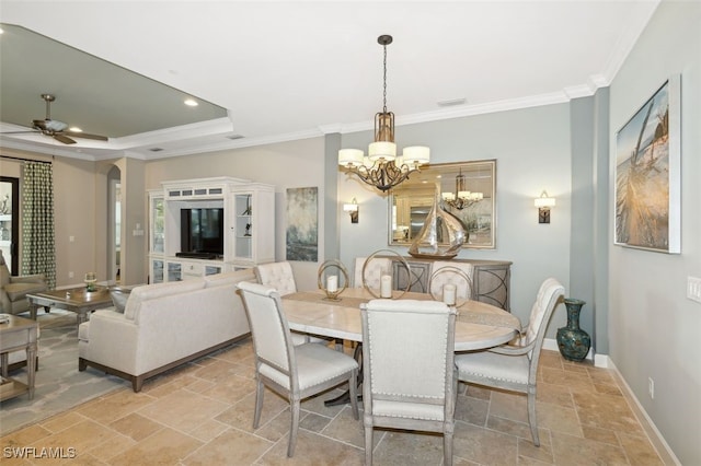 dining room featuring ceiling fan with notable chandelier, a raised ceiling, and ornamental molding