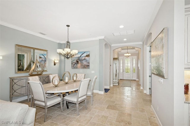 dining area featuring crown molding and an inviting chandelier