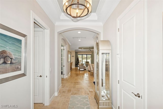 corridor with a raised ceiling and ornamental molding