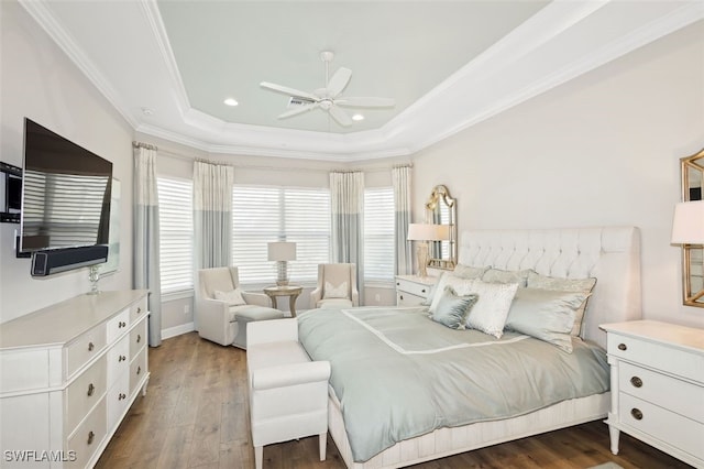 bedroom featuring a raised ceiling, ceiling fan, ornamental molding, multiple windows, and dark hardwood / wood-style flooring